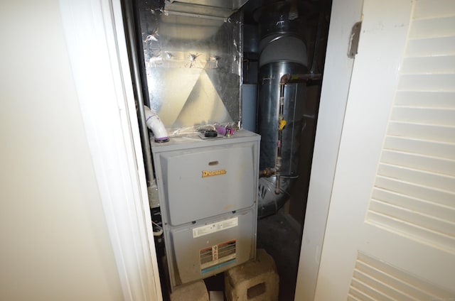 utility room featuring heating unit