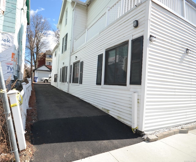 view of side of property featuring an outbuilding