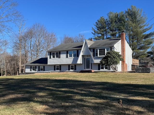 bi-level home featuring a front yard and a chimney