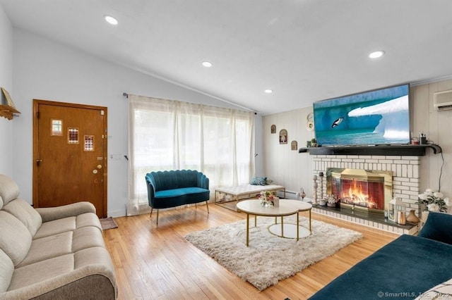 living room with a fireplace, lofted ceiling, a baseboard radiator, recessed lighting, and wood finished floors