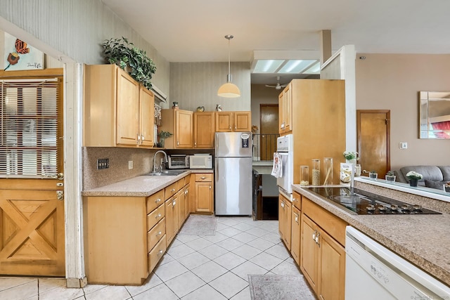 kitchen featuring pendant lighting, light tile patterned floors, tasteful backsplash, light countertops, and white appliances