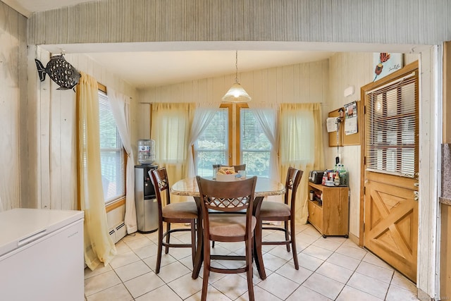 dining space featuring a wealth of natural light, light tile patterned flooring, and lofted ceiling