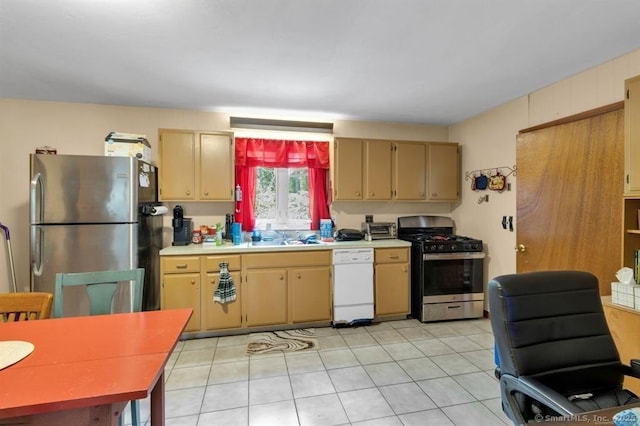 kitchen featuring light tile patterned floors, appliances with stainless steel finishes, light countertops, and a sink