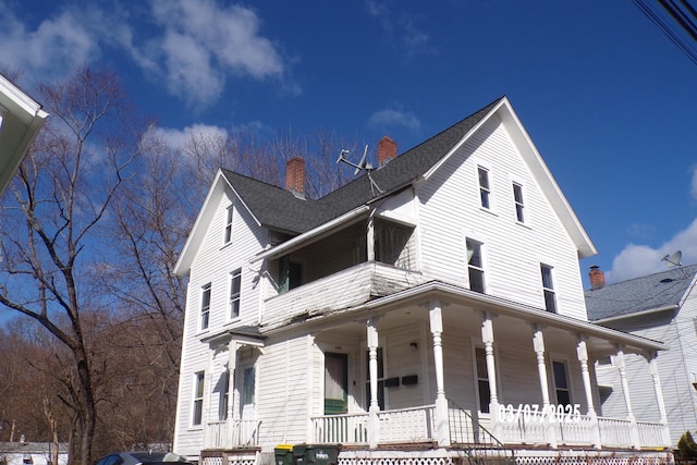 view of front of property with a porch and a shingled roof