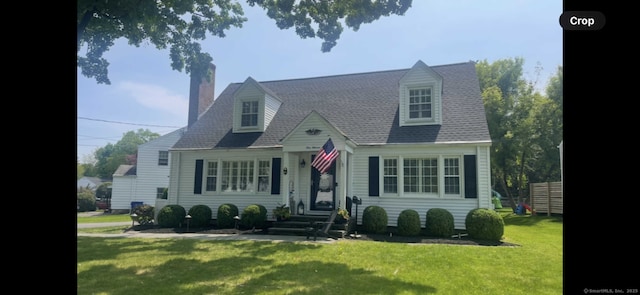 cape cod home with a front lawn