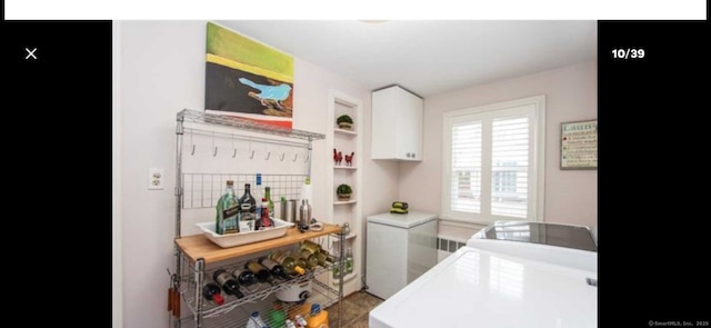 kitchen with open shelves, refrigerator, light countertops, and white cabinetry