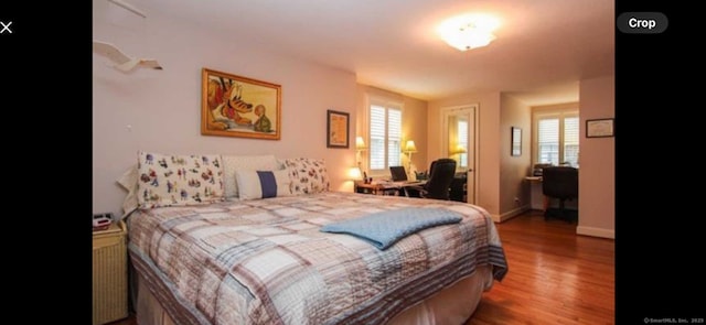 bedroom with baseboards and wood finished floors