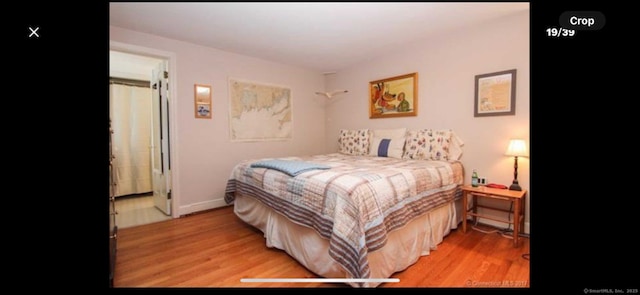 bedroom featuring baseboards and wood finished floors