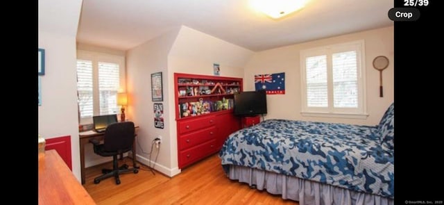 bedroom featuring baseboards and wood finished floors