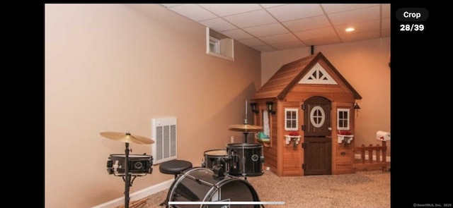 workout room with carpet, a paneled ceiling, visible vents, and baseboards