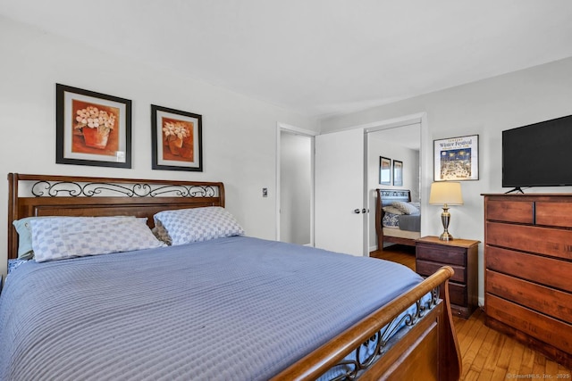 bedroom with a closet and hardwood / wood-style flooring