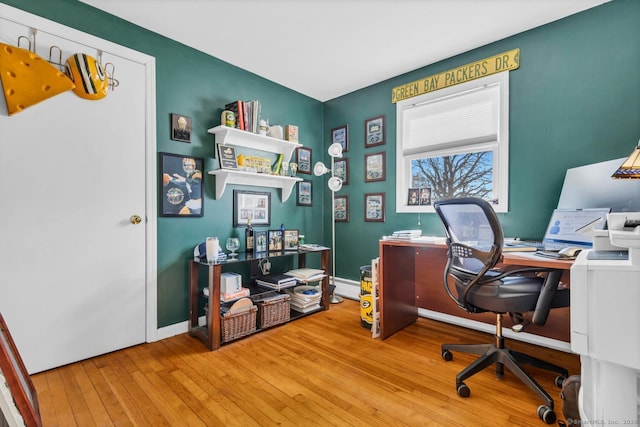 home office with baseboards and wood-type flooring