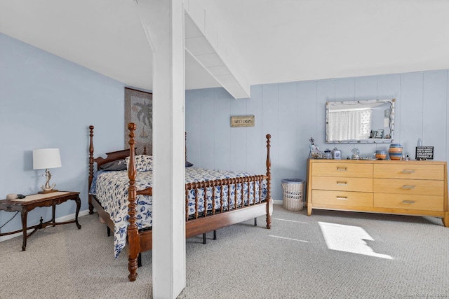 carpeted bedroom featuring baseboards and beam ceiling