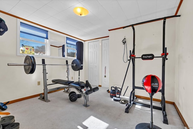 workout room with baseboards and carpet