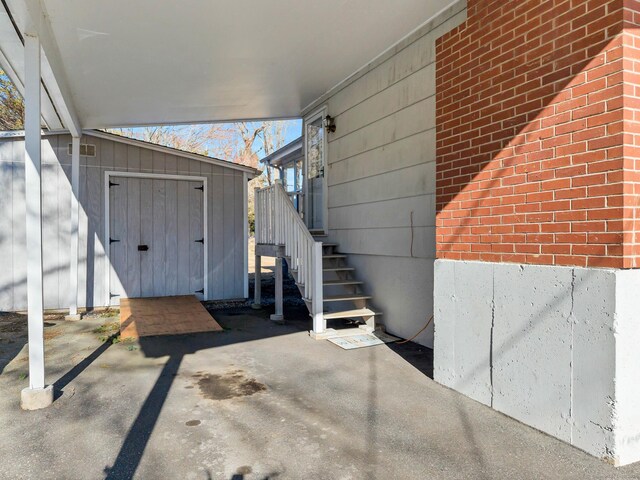 view of patio / terrace featuring a storage unit and an outdoor structure