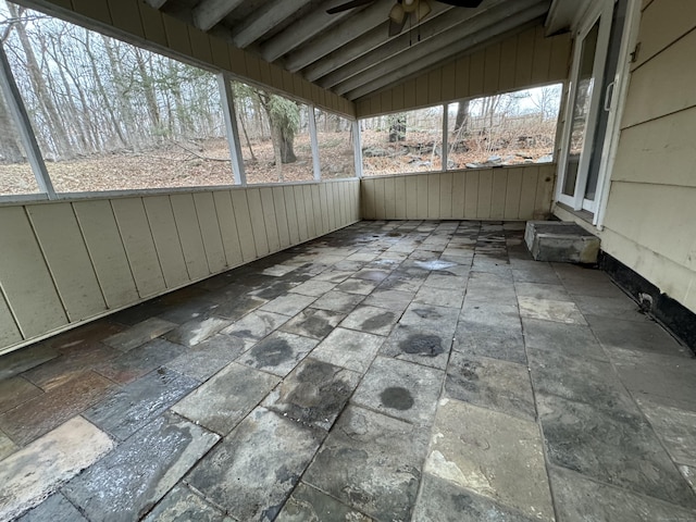 unfurnished sunroom with lofted ceiling and ceiling fan