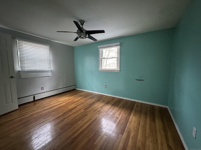 unfurnished room featuring a ceiling fan, baseboards, baseboard heating, and hardwood / wood-style floors