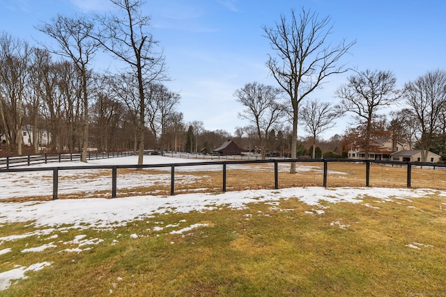 yard layered in snow with fence