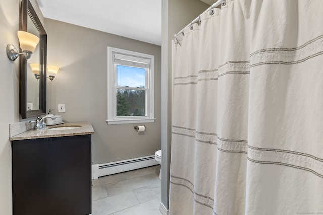 bathroom with tile patterned floors, baseboard heating, vanity, and toilet