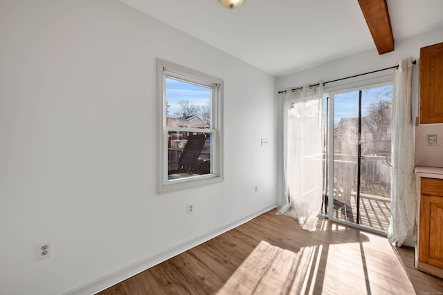 interior space with beamed ceiling and light wood-style floors