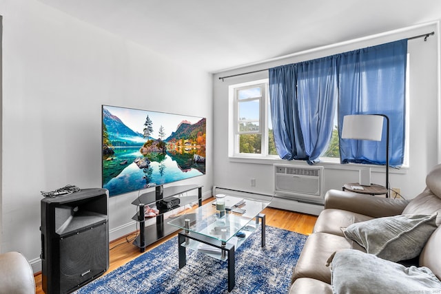 living room with baseboards, baseboard heating, wood finished floors, and a wall mounted AC