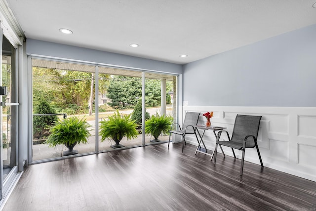 sitting room featuring wainscoting, a decorative wall, recessed lighting, and wood finished floors