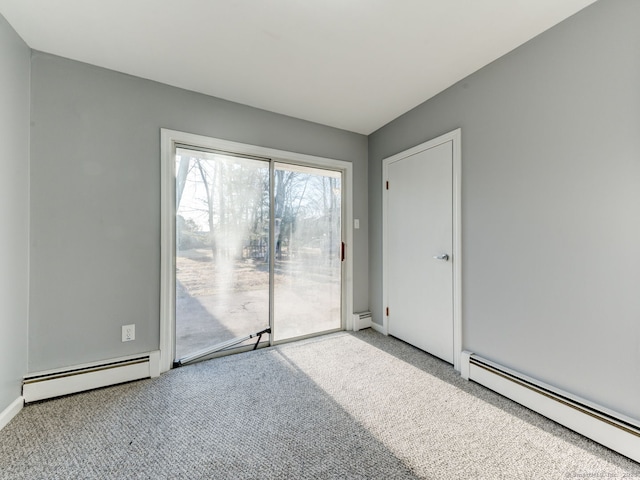 unfurnished room featuring a baseboard heating unit, carpet floors, and baseboards