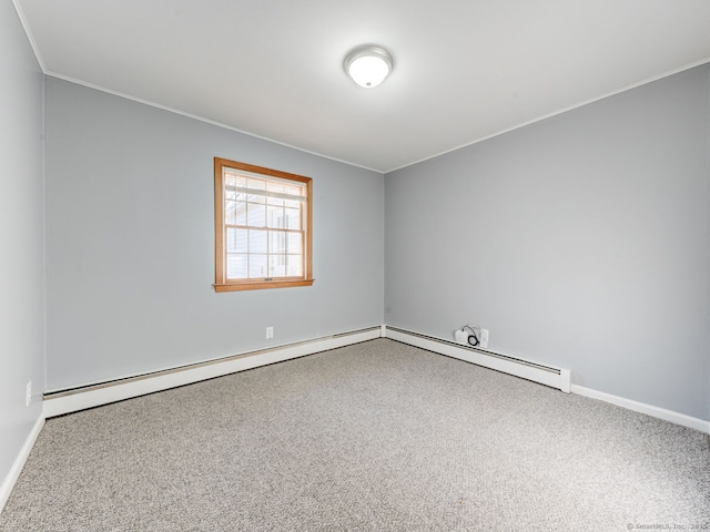 carpeted empty room featuring a baseboard heating unit, baseboards, and crown molding