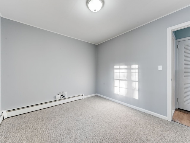 carpeted spare room featuring baseboards, baseboard heating, and ornamental molding