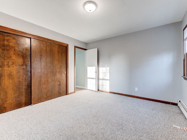 unfurnished bedroom featuring a closet, baseboards, and carpet