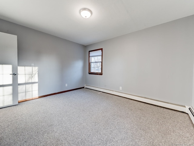 empty room with a baseboard radiator, baseboards, and carpet