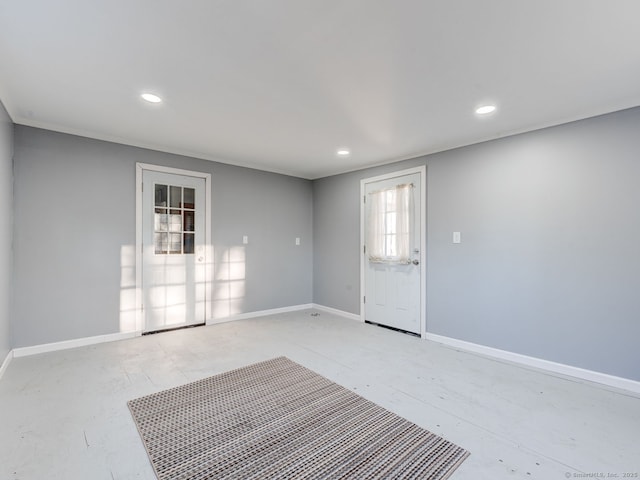 entryway featuring recessed lighting, concrete floors, and baseboards