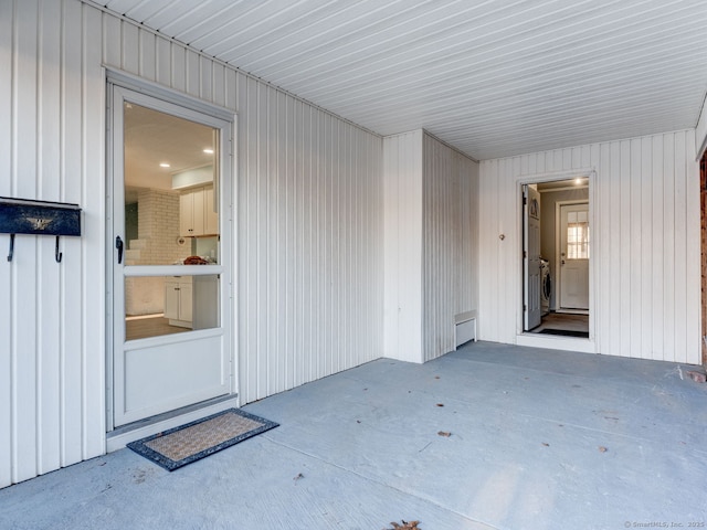 entrance to property featuring independent washer and dryer