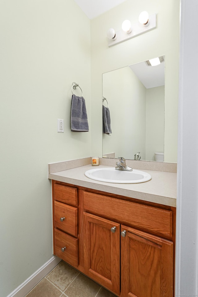 bathroom featuring baseboards, vanity, and tile patterned flooring