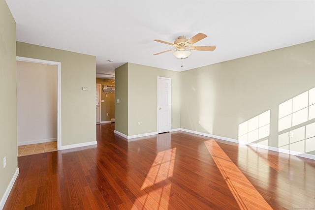 unfurnished room featuring baseboards, a ceiling fan, and wood finished floors