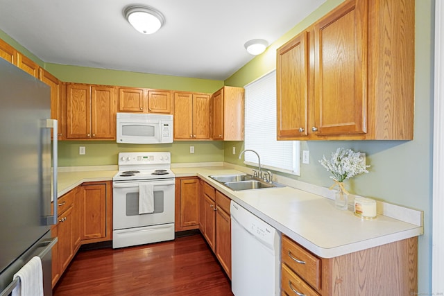 kitchen with white appliances, light countertops, and a sink