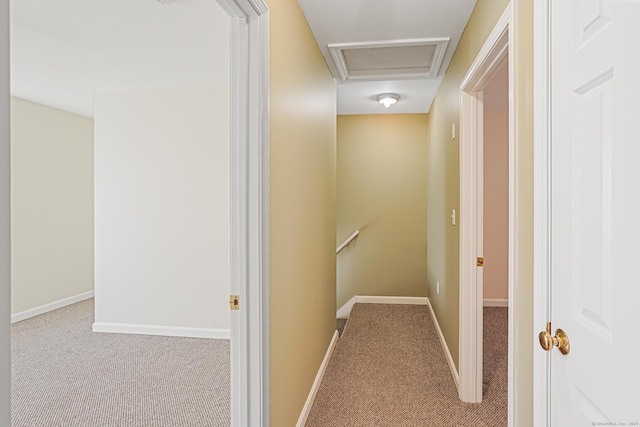 corridor with baseboards, carpet, and an upstairs landing