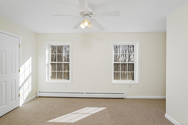 carpeted empty room featuring a ceiling fan, baseboards, and a baseboard radiator