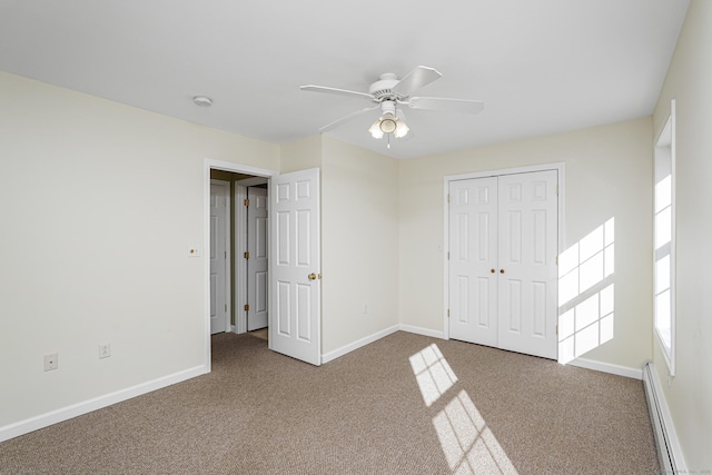 unfurnished bedroom featuring carpet floors, baseboards, and a baseboard radiator