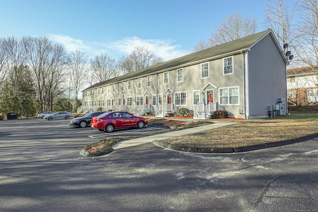 view of property featuring uncovered parking