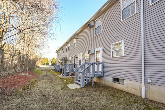 view of side of home featuring a wall mounted AC