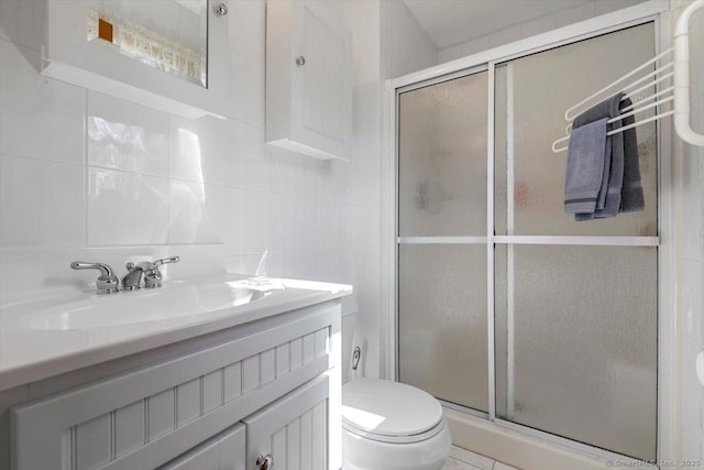 full bathroom featuring tasteful backsplash, toilet, vanity, a shower stall, and tile walls