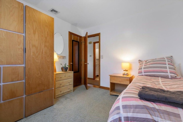 bedroom featuring light carpet, visible vents, and baseboards