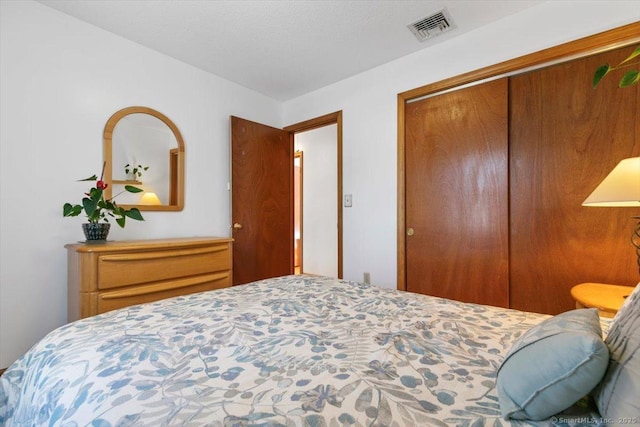 bedroom featuring a closet and visible vents