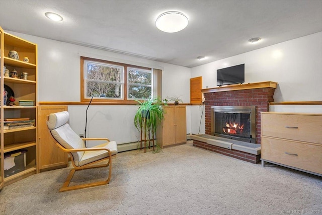 living area with carpet, baseboard heating, and a brick fireplace