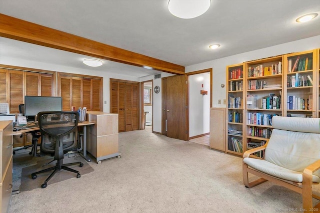 home office with beam ceiling, light colored carpet, and baseboards