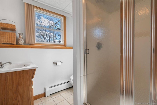 full bathroom with toilet, tile patterned floors, baseboard heating, vanity, and a shower stall