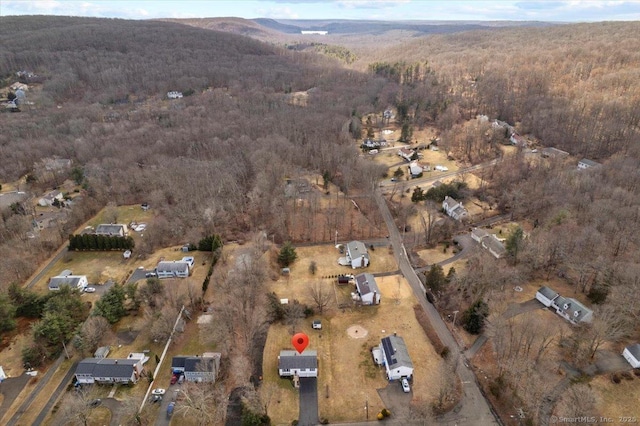 drone / aerial view featuring a mountain view and a forest view