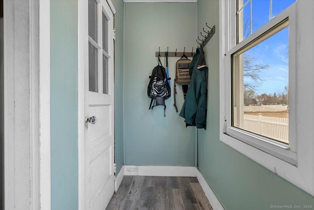 doorway featuring dark wood finished floors and baseboards