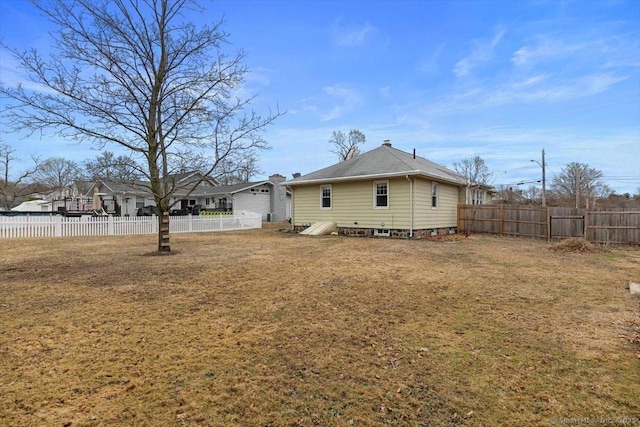 exterior space with a fenced backyard and a yard